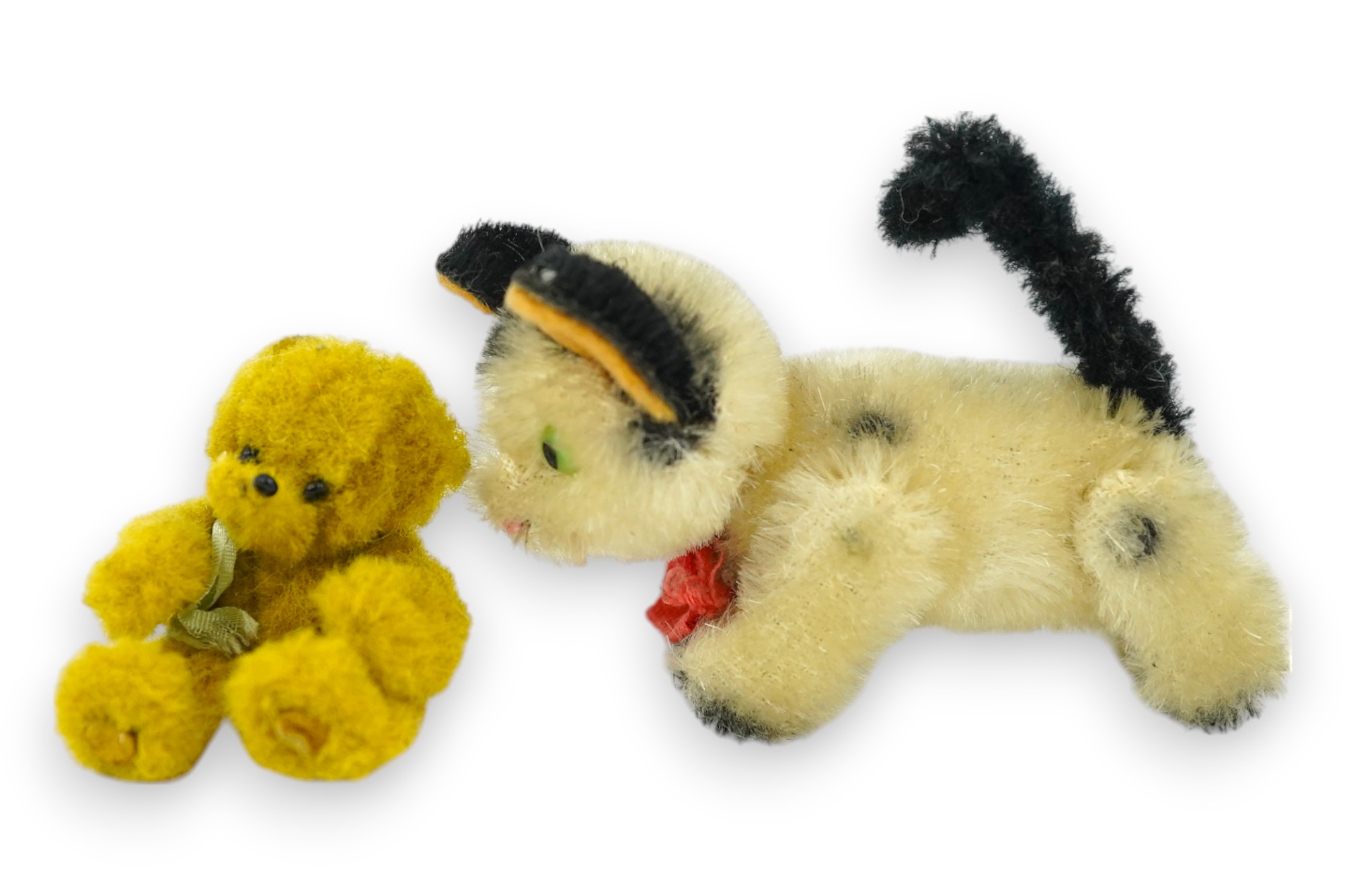 A small Schuco cat with revolving head and a tiny jointed teddy bear, largest 9cm in length. Condition - fair to good